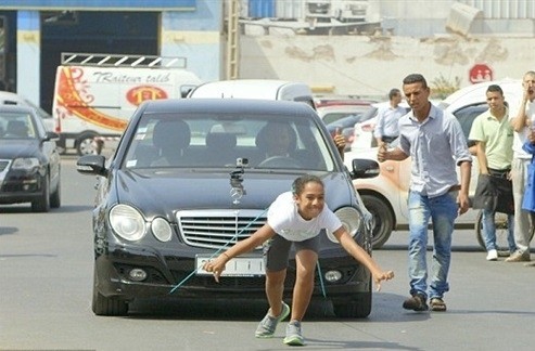 بالفيديو: فتاة مغربية تشدّ سيارة بشعرها